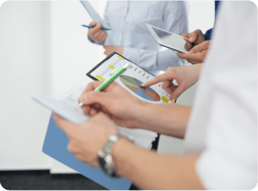 Hands holding a clipboard with a pie chart and data, representing patient experience surveys and feedback.