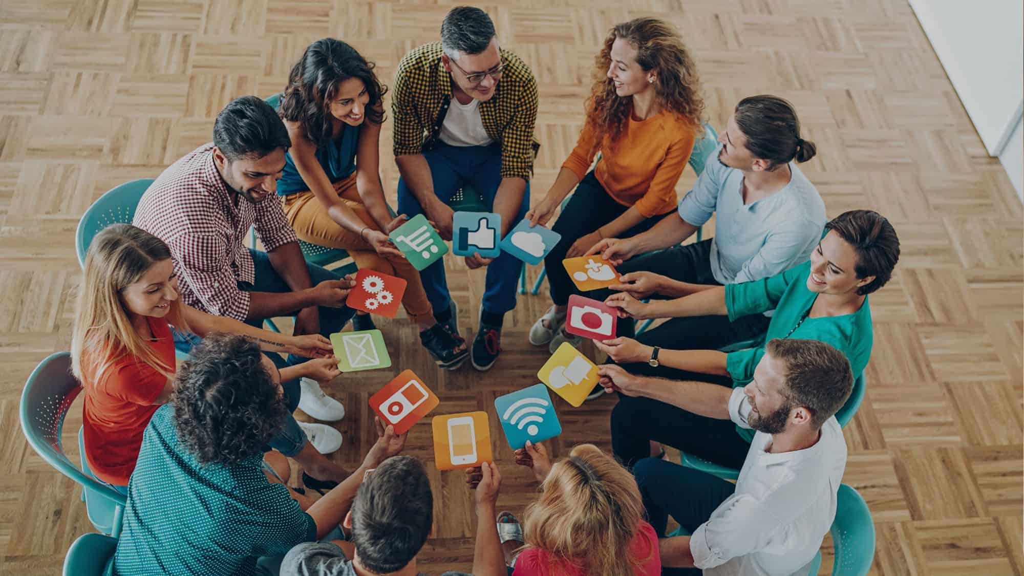 Group holding social media app icons in circle.